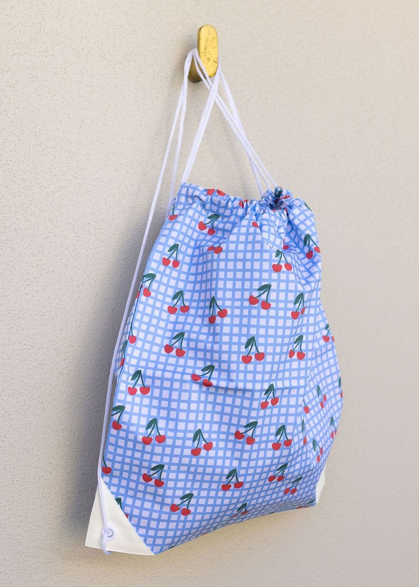 Cherry Checks Swim Bag by Acorn Kids featuring a colorful cherry check pattern and practical design for swimming gear storage.