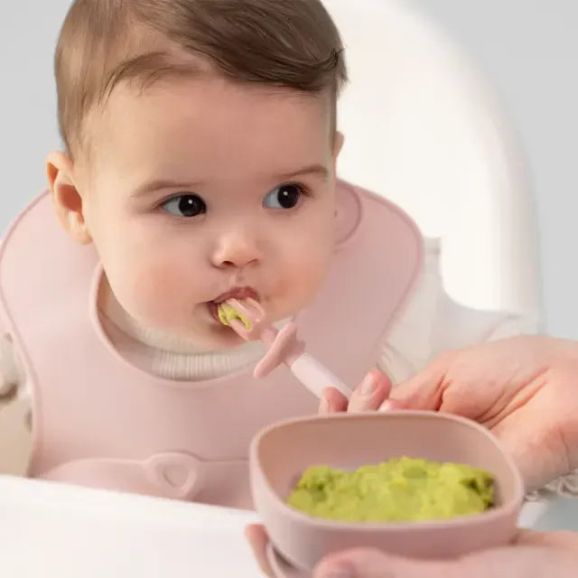 B.Box Weaning Cutlery Trio in blush, soft silicone feeding utensils for babies, includes fork, spoon, and knife.