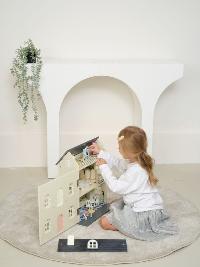 Vintage wooden dolls house by Classic World, featuring detailed miniature rooms and furniture for imaginative play.