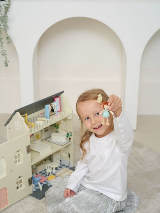Vintage wooden dolls house by Classic World, featuring detailed miniature rooms and furniture for children's imaginative play.