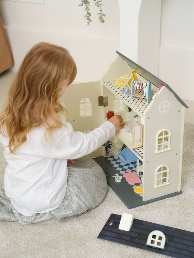 Vintage wooden dolls house by Classic World featuring detailed miniature rooms and classic toy design for children.