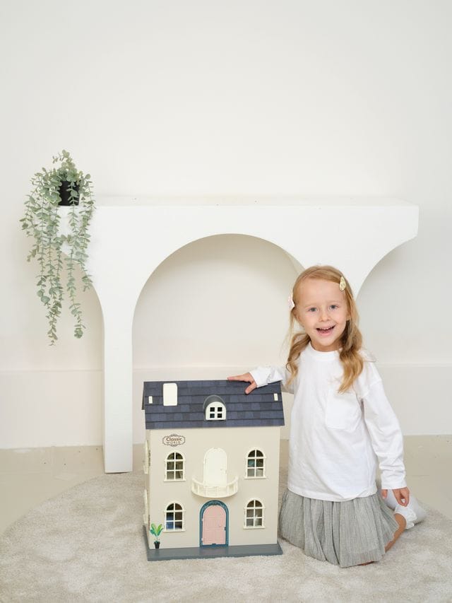 Vintage wooden dolls house from Classic World, featuring detailed rooms and classic toy design for imaginative play.