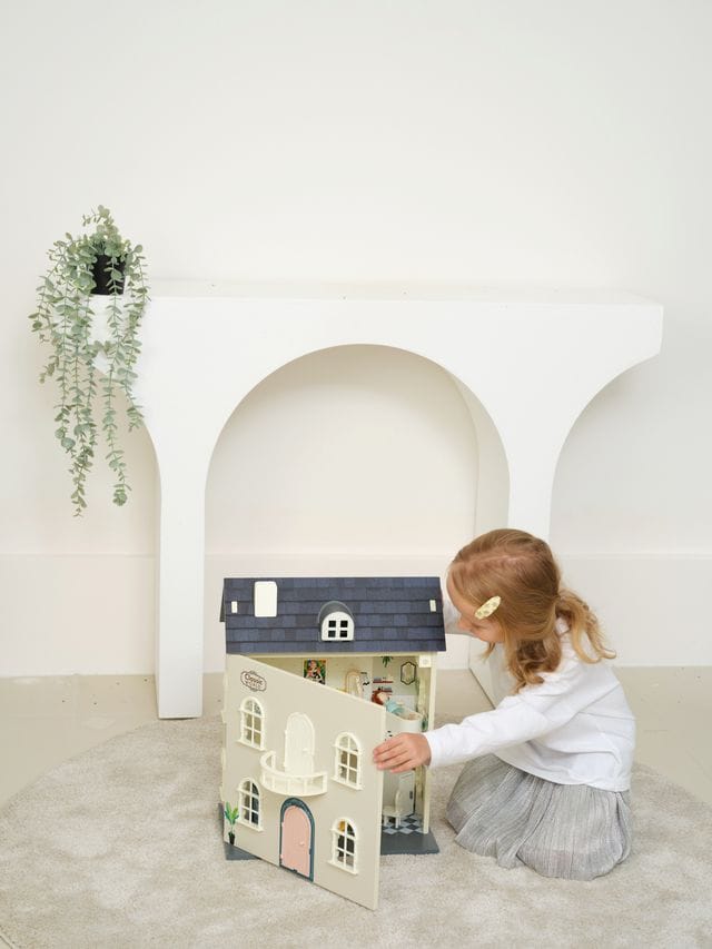 Vintage wooden dolls house by Classic World, featuring detailed miniature rooms and furniture for imaginative play.
