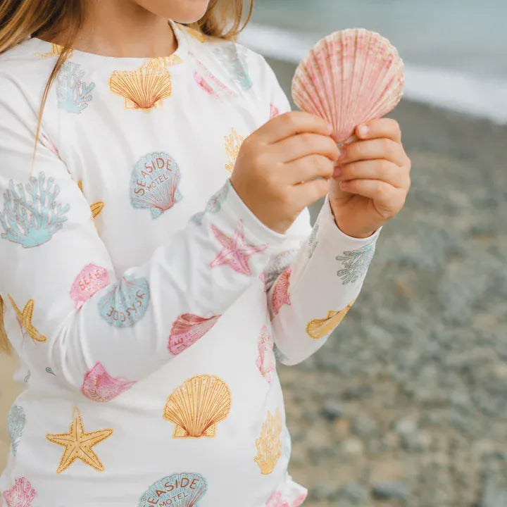 Crywolf Shell long sleeve swimsuit in a neutral shell print with full coverage design