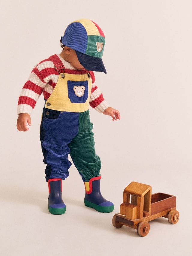 Huxbaby boys colour block cord overalls with adjustable straps and front pockets, made from soft, durable fabric.