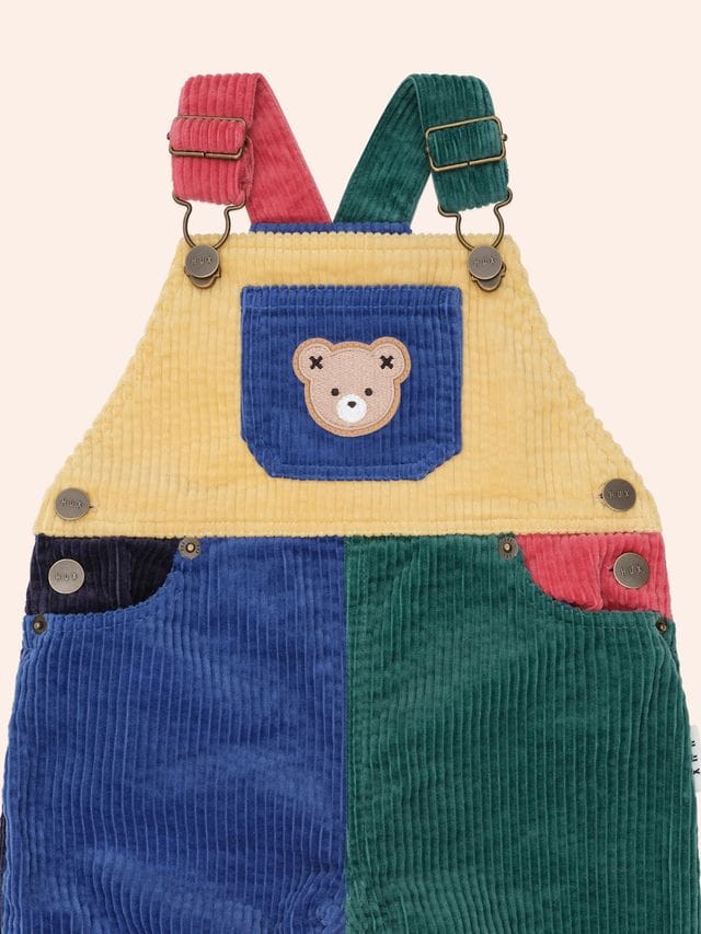 Huxbaby boys color block cord overalls with adjustable straps and front pockets, featuring vibrant patchwork design.