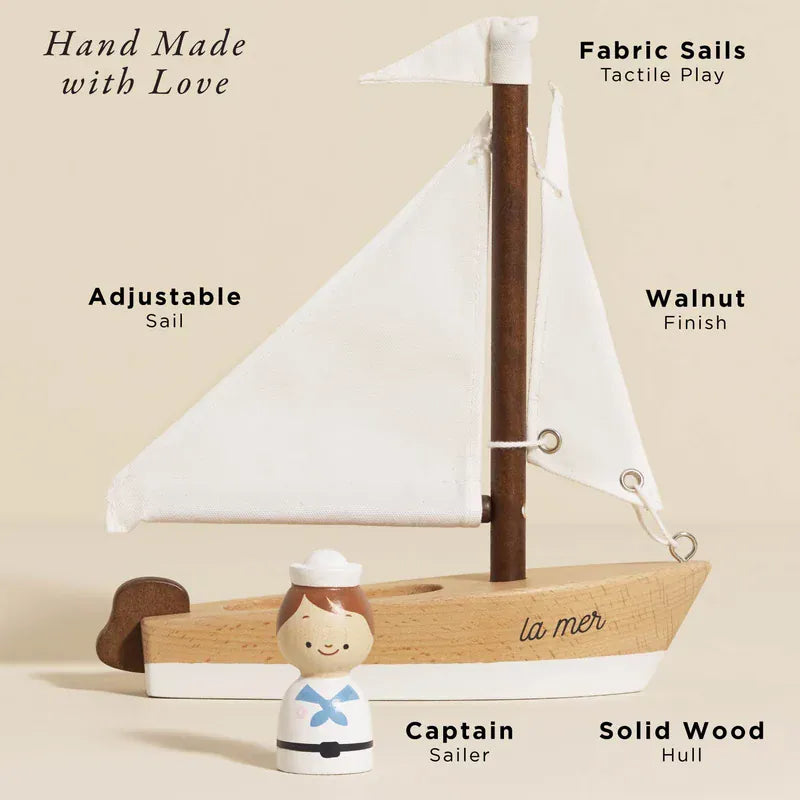 Le Toy Van wooden sailing boat toy with captain figurine, visible in natural wood finish