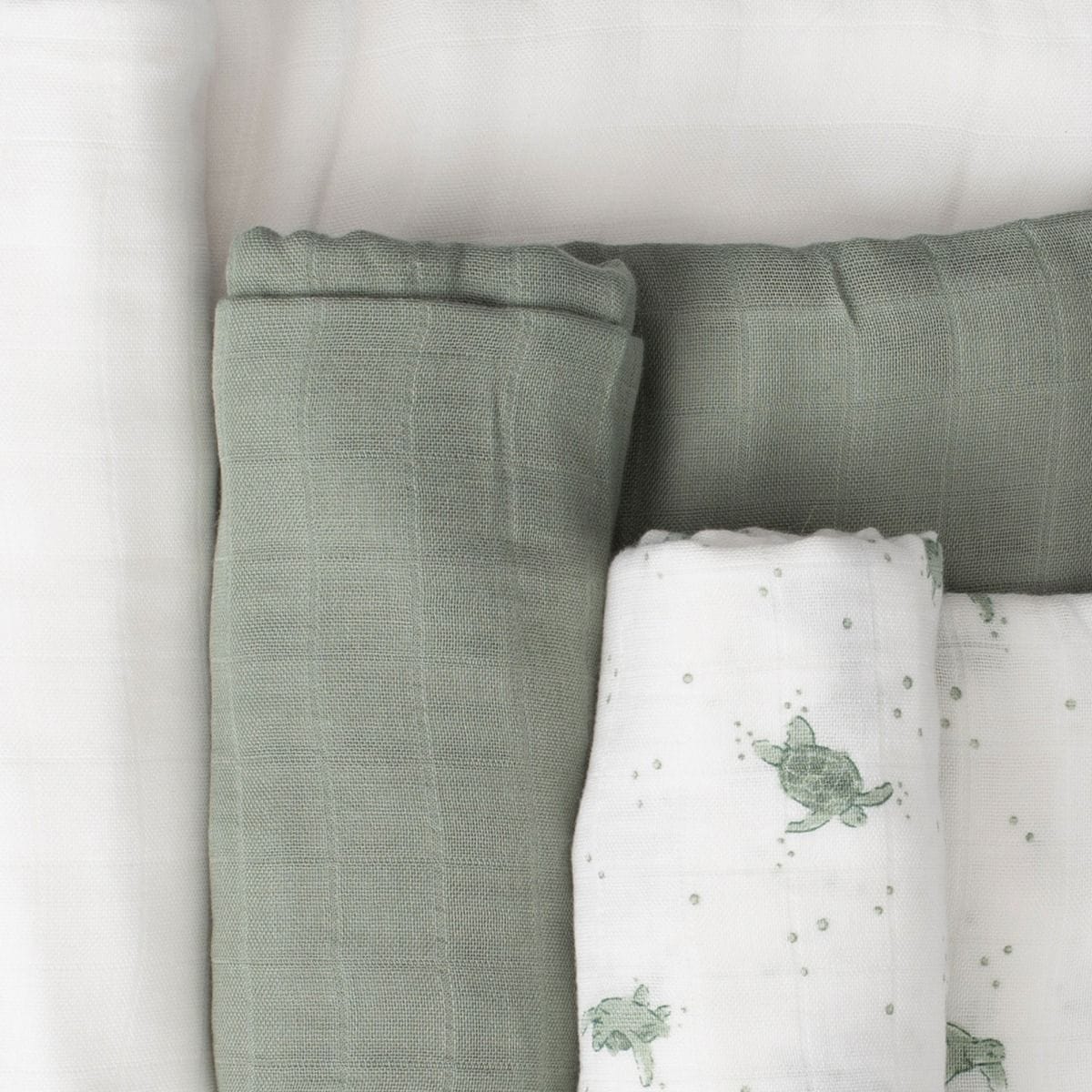 Three Little Bamboo Muslin Wraps in Turtle Bay print, soft baby accessories made of breathable bamboo fabric.