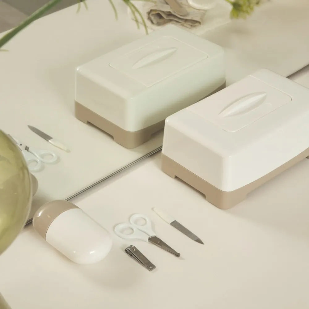 LUMA Baby Manicure Set in white with baby nail scissors and clippers for gentle nail care in a compact case.