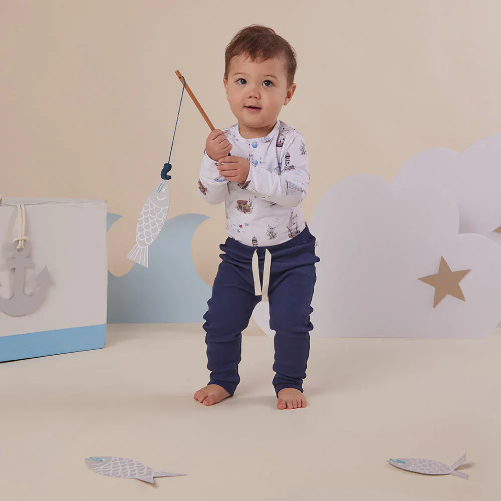 Snuggle Hunny Kids boys long sleeve organic bodysuit with sailboat print, comfortable onesie perfect for everyday wear.