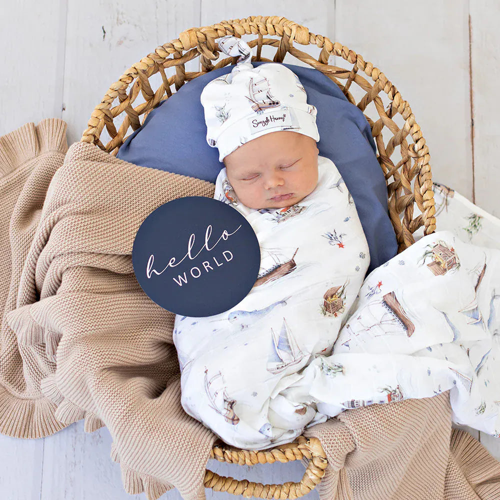 Set Sail organic muslin wrap by Snuggle Hunny Kids, soft linen sheets with nautical print, perfect for cozy baby bedding.