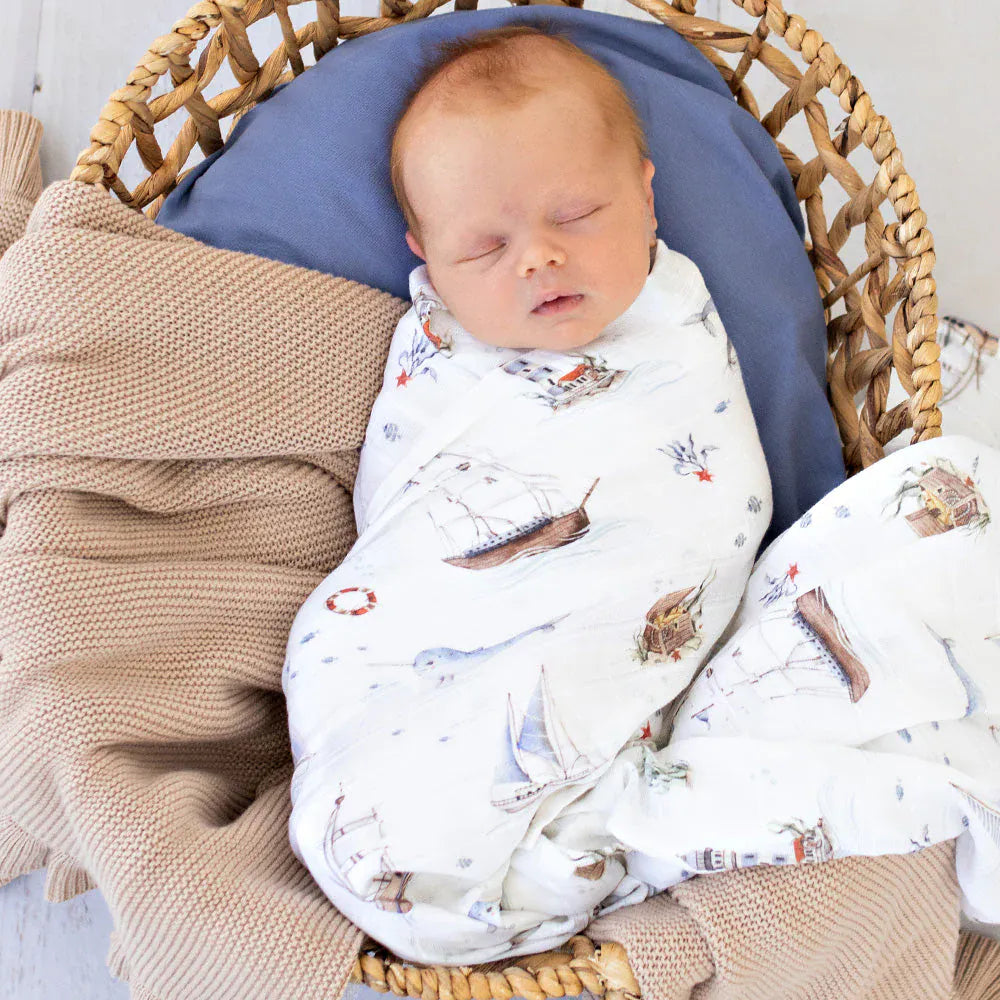 Snuggle Hunny Kids Set Sail organic muslin wrap with linen sheets, featuring a nautical print and soft, breathable fabric.