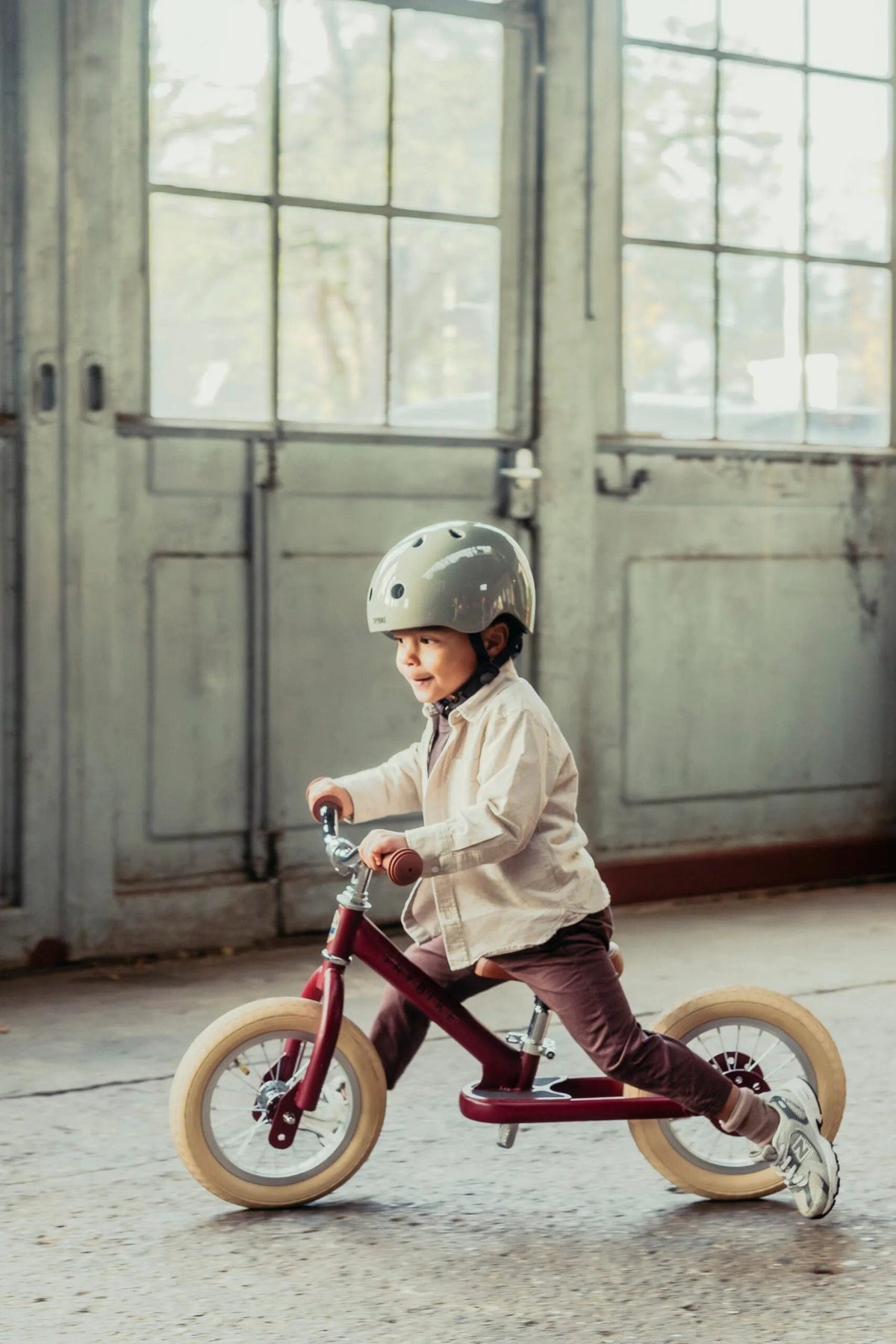 Trybike Vintage Red ride-on toy for kids, featuring a classic red design with a sturdy build and ergonomic handles.