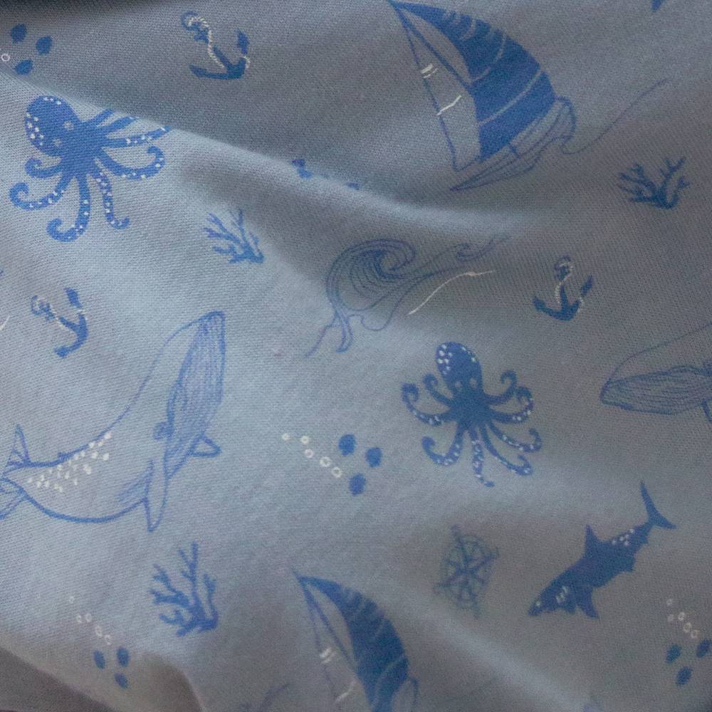 Unisex Woolbabe winter pyjamas made of merino and organic cotton in glacier sail away design, featuring cozy sleepwear for cold nights.