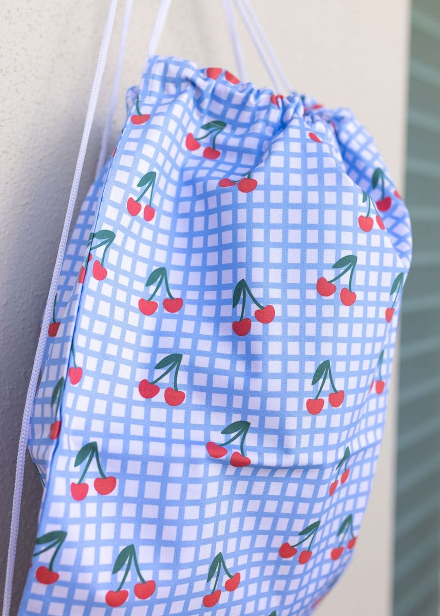 Acorn Kids Cherry Checks Swim Bag with adjustable strap, colorful cherry check pattern, perfect for kids' swimming gear storage.