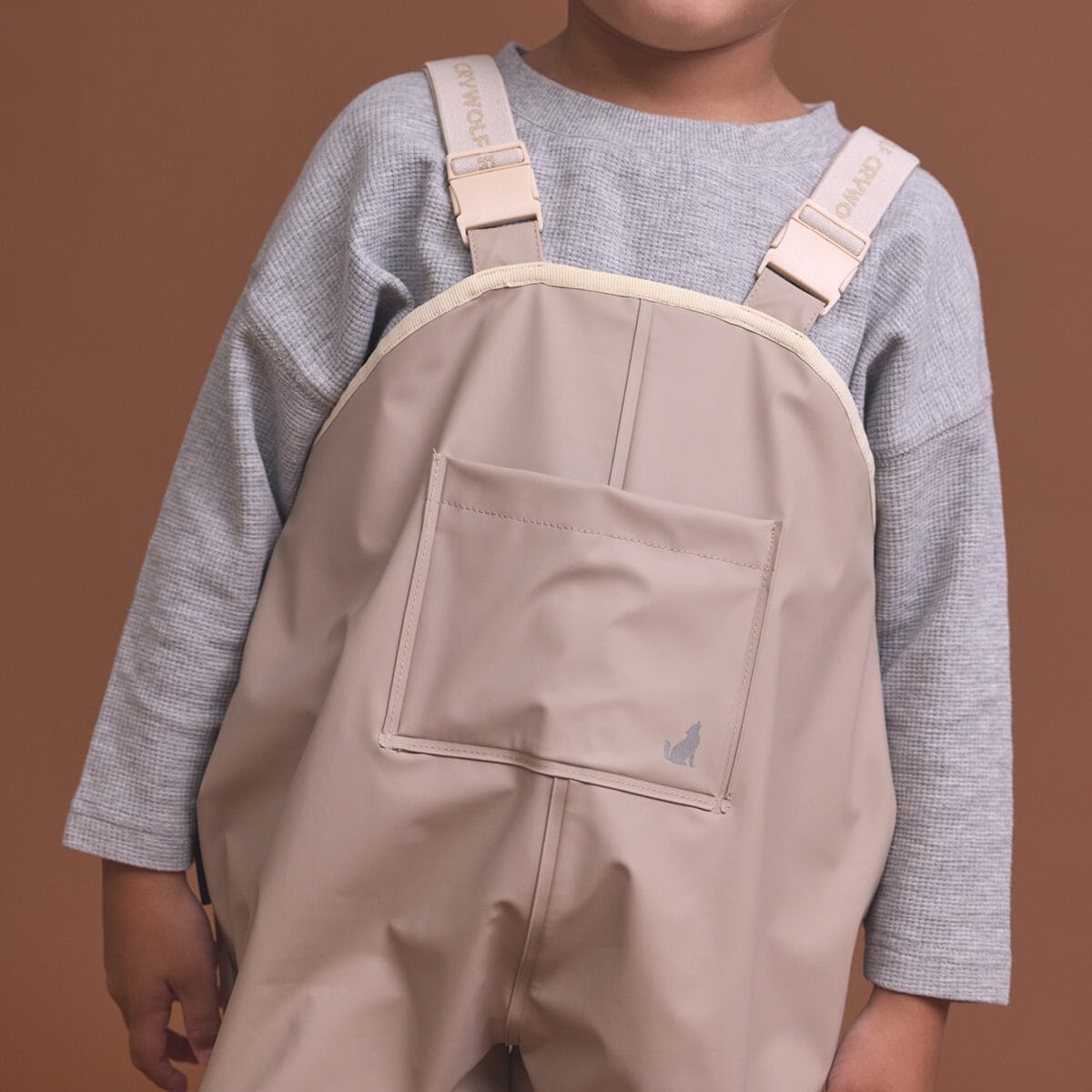 Crywolf unisex rain overalls in ash color, durable waterproof pants for wet weather, featuring adjustable straps and a relaxed fit.