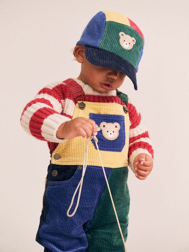 Huxbaby boys color block cord overalls featuring a playful design, front pockets, adjustable straps, and vibrant color blocking.