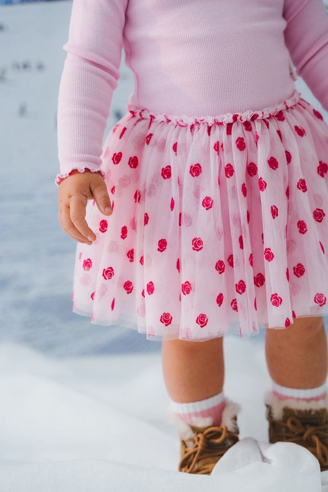 Girls dress by Huxbaby with rose embroidery, made of tulle fabric, featuring a delicate and elegant design.