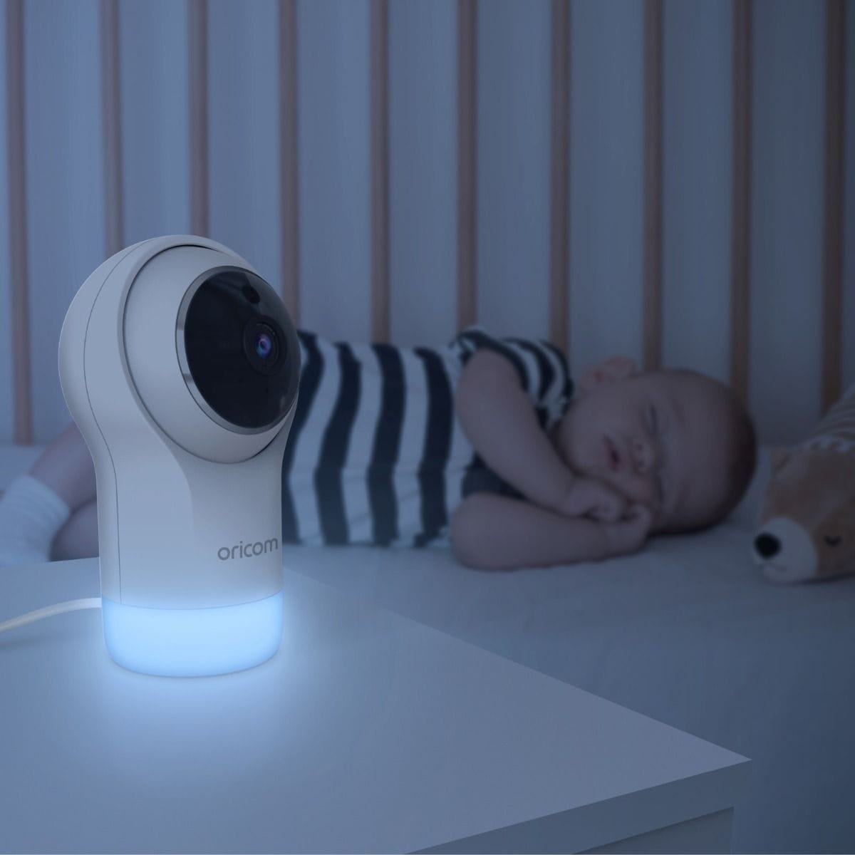 Oricom 5" Smart HD Nursery Pal Glow+ baby monitor with camera and baby care features, displayed in a nursery setting.