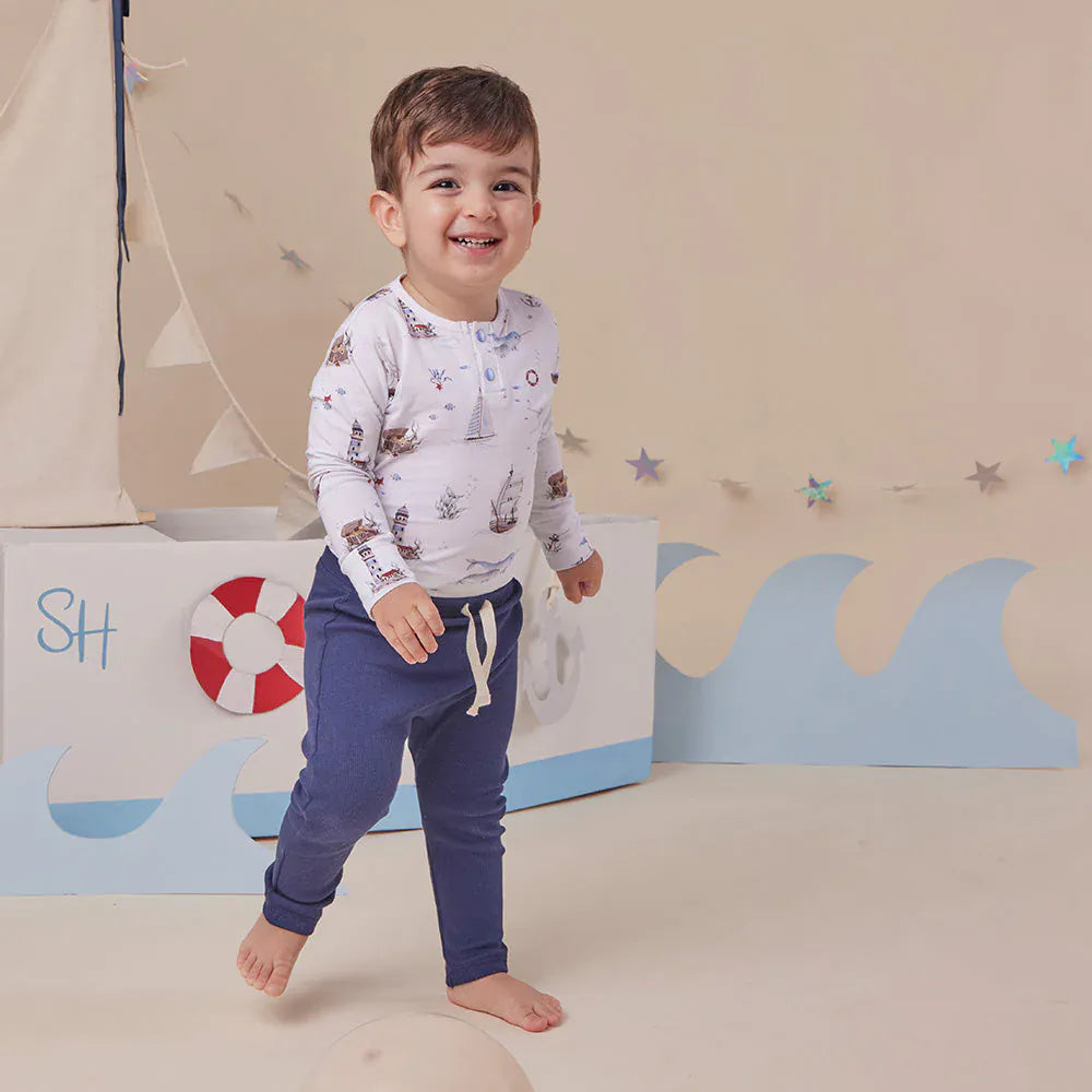 Snuggle Hunny Kids boys long sleeve organic bodysuit with sailboat print, soft and comfortable for baby boys.