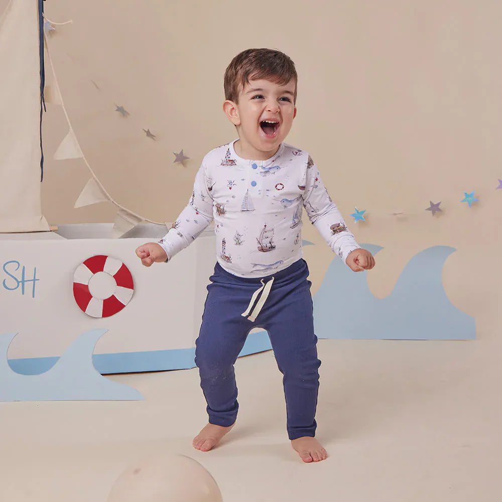 Snuggle Hunny Kids boys long sleeve organic bodysuit with sailboat print, comfortable and soft for little ones.