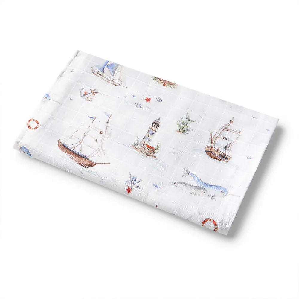 Snuggle Hunny Kids Set Sail Organic Muslin Wrap with linen sheets, soft and breathable for baby comfort and cozy sleep.