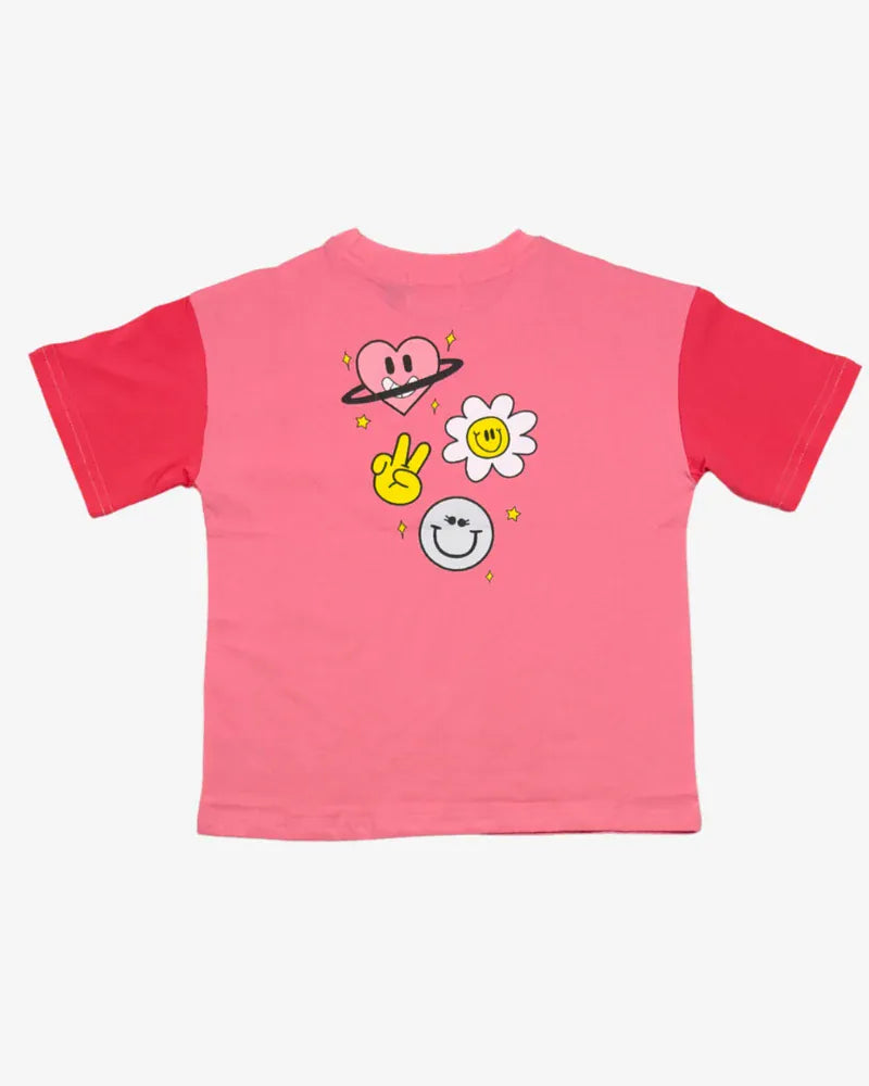 Coral girls' top by The Girl Club featuring a cheerful happy icons design, perfect for casual wear.