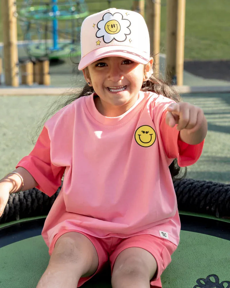 Coral girls' top by The Girl Club featuring a happy icons graphic and a casual, comfortable fit.