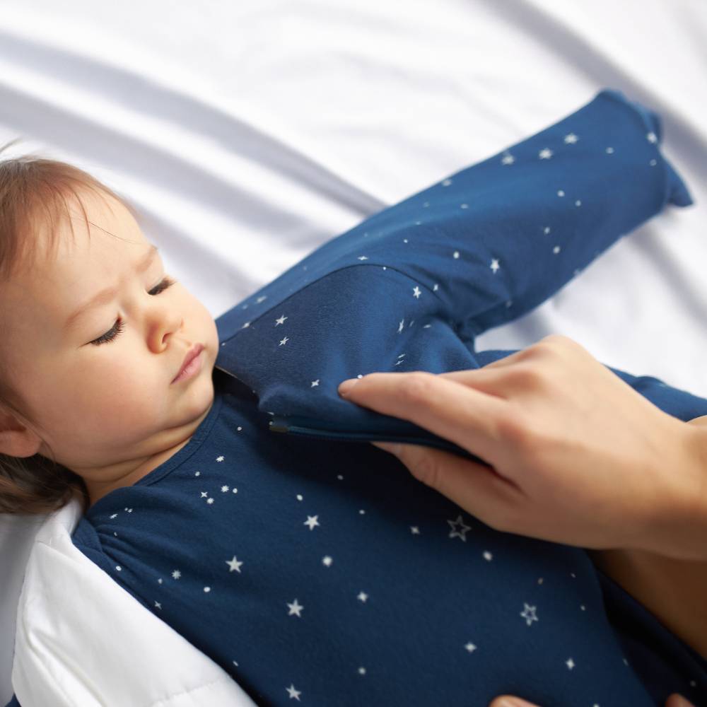 Woolbabe linen duvet front zip sleeping bag with sleeves, featuring a Tekapo Stars design for infants aged 6-24 months.