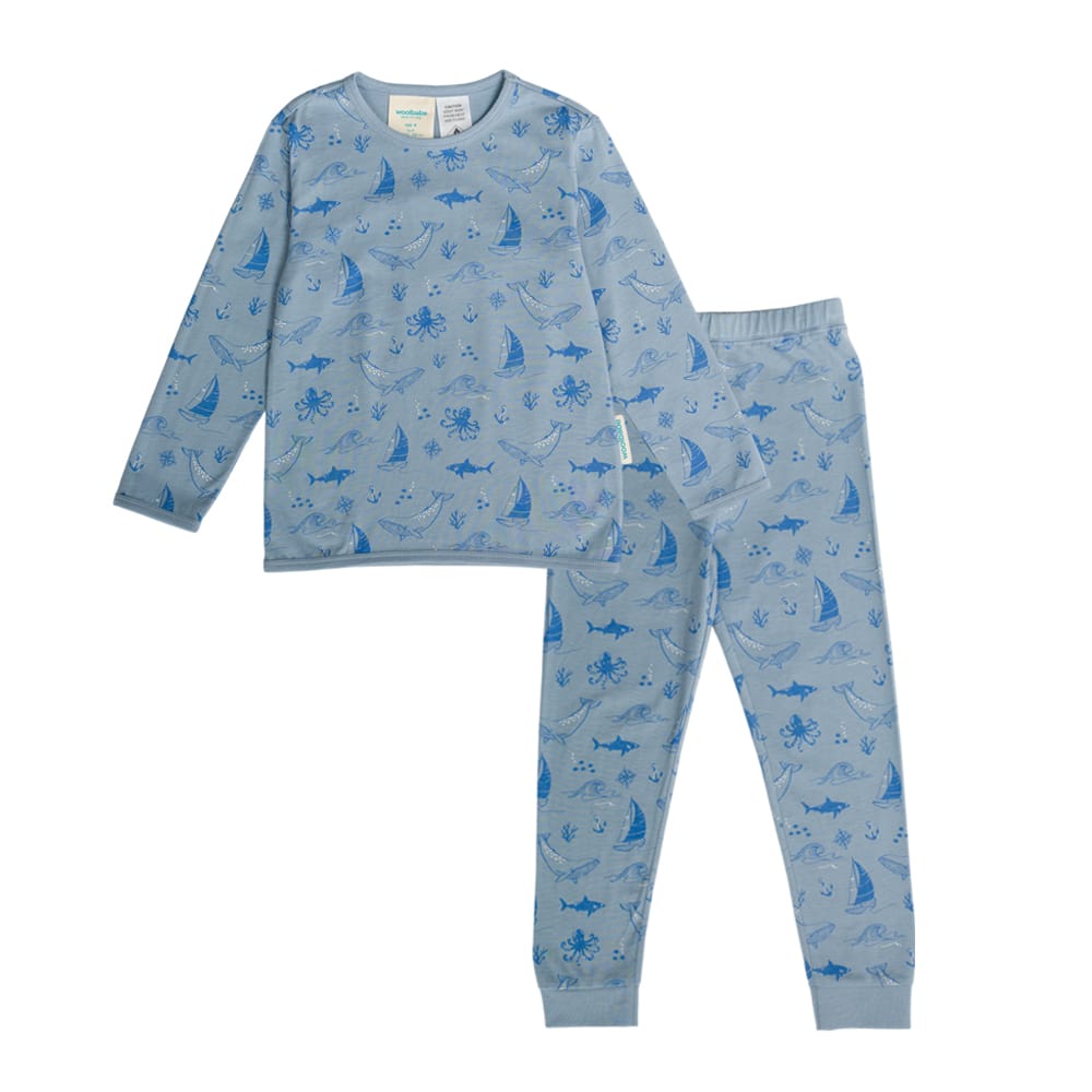Unisex Woolbabe merino and organic cotton winter pajamas in Glacier Sail Away print, featuring cozy, soft sleepwear for cold nights.
