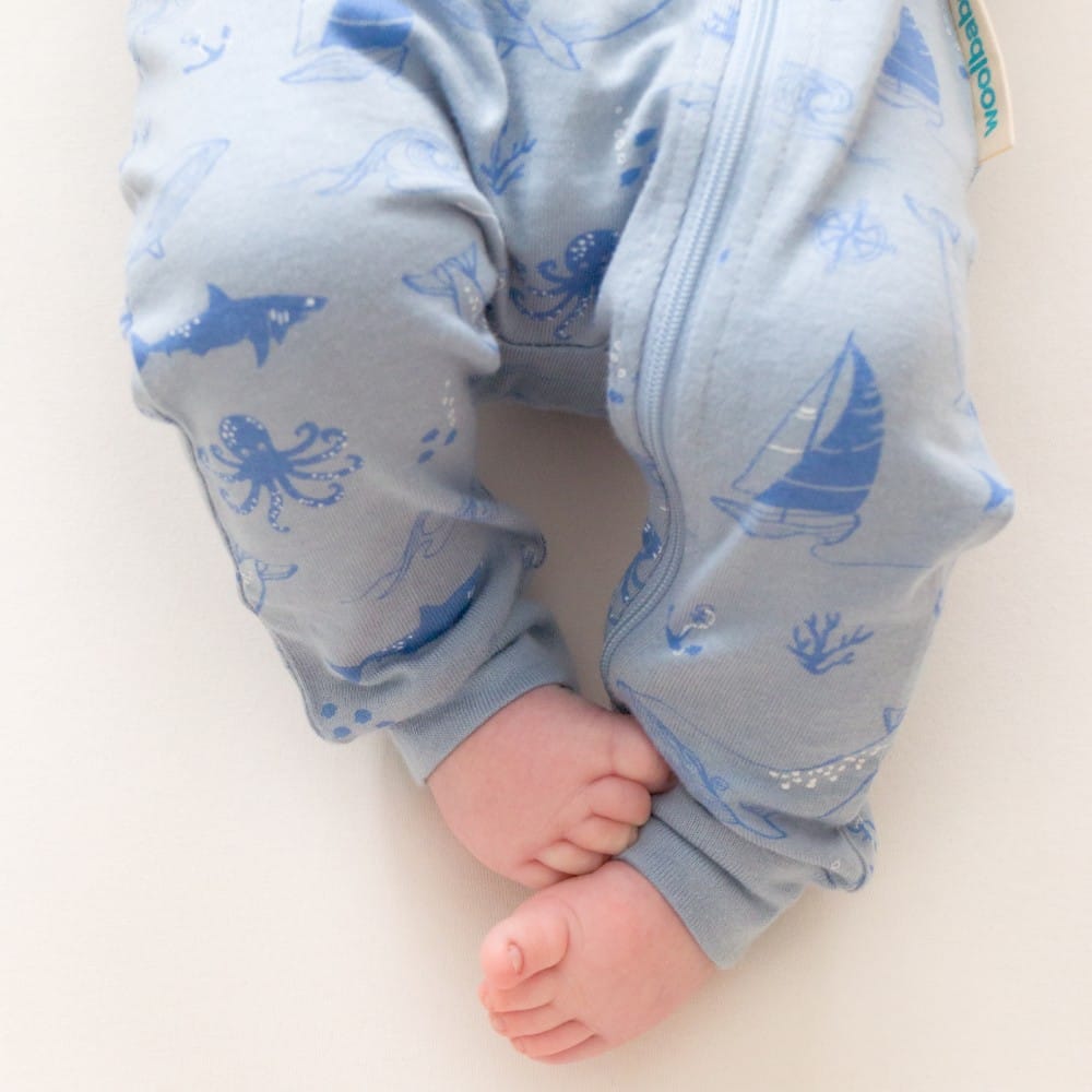 Unisex Woolbabe Merino and organic cotton PJ suit in Glacier Sail Away print, cozy sleepwear for comfortable nights.